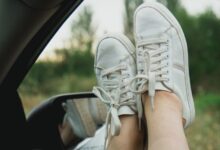 person wearing white lace up sneakers