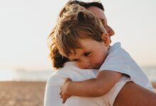 boy hugging woman during daytime
