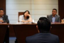 man in black shirt sitting beside woman in white shirt
