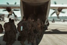 group of men in camouflage uniform standing near white airplane