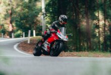 man in black helmet riding motorcycle on road during daytime