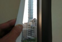 Person Holding White Paper Near Window