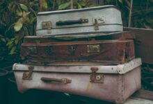 brown suitcase on white table