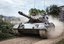 battle tank on green grass field during daytime
