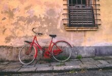 red bike leaned on wall