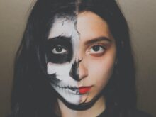 woman with skull paint on her half face