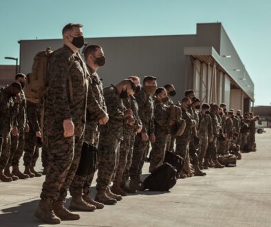 men in black and brown camouflage uniform standing on brown floor