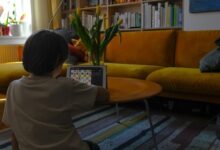 woman in white shirt sitting on yellow couch