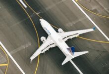 white and blue airplane on airport during daytime