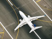 white and blue airplane on airport during daytime