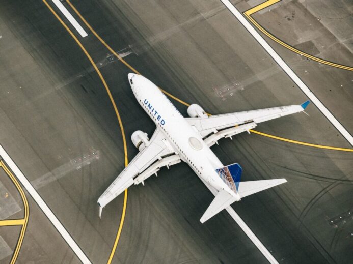white and blue airplane on airport during daytime