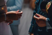 closeup photo of person's hand holding rings