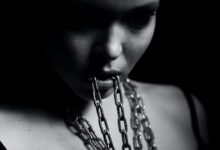grayscale photo of woman with chain