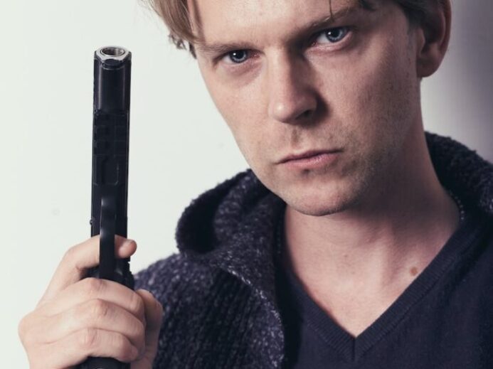 man in black v neck shirt holding black microphone