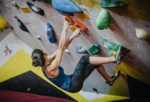 woman rock climbing inside building