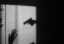 silhouette of person on window