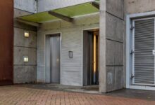 gray wooden door on brown brick wall