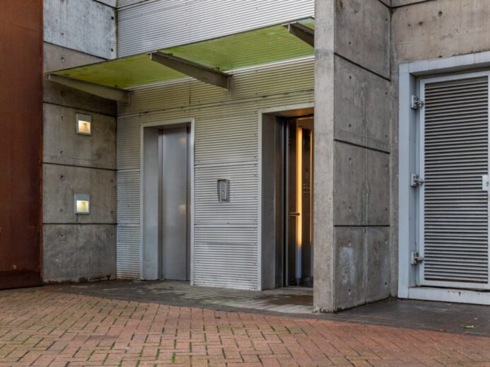 gray wooden door on brown brick wall
