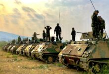 soldiers on top of battle tanks