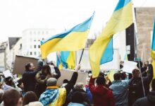 People Gathering on Street Holding Ukraine Flags