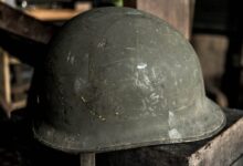 grey helmet on brown wooden table