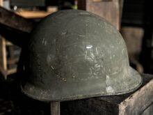 grey helmet on brown wooden table