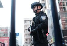 police holding rifle while standing