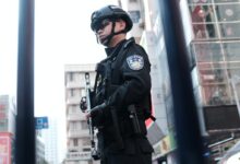 police holding rifle while standing