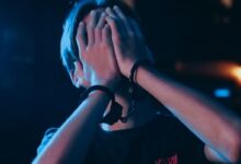 Man in Black Crew Neck T-shirt Covering His Face With His Hand
