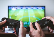 two people playing Sony PS4 game console