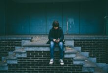 boy sitting on concrete stairs