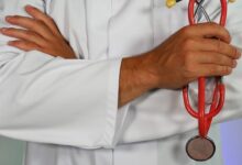 doctor holding red stethoscope