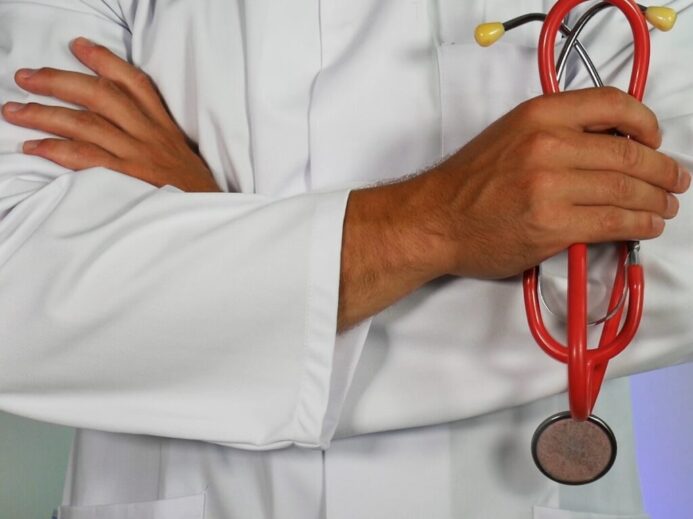 doctor holding red stethoscope