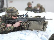 man in green and brown camouflage army suit holding rifle