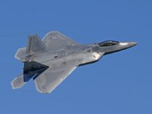 flying gray jet plane