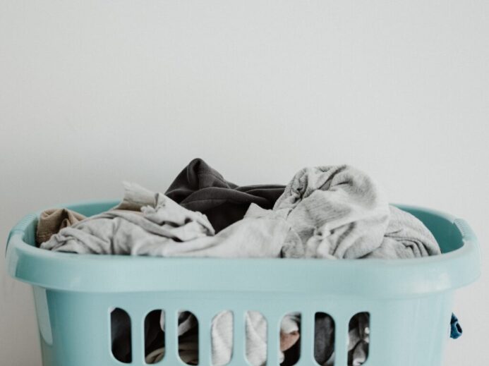 white textile on blue plastic laundry basket