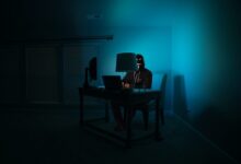 man facing laptop