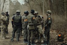 group of soldiers in camouflage uniform standing on ground during daytime