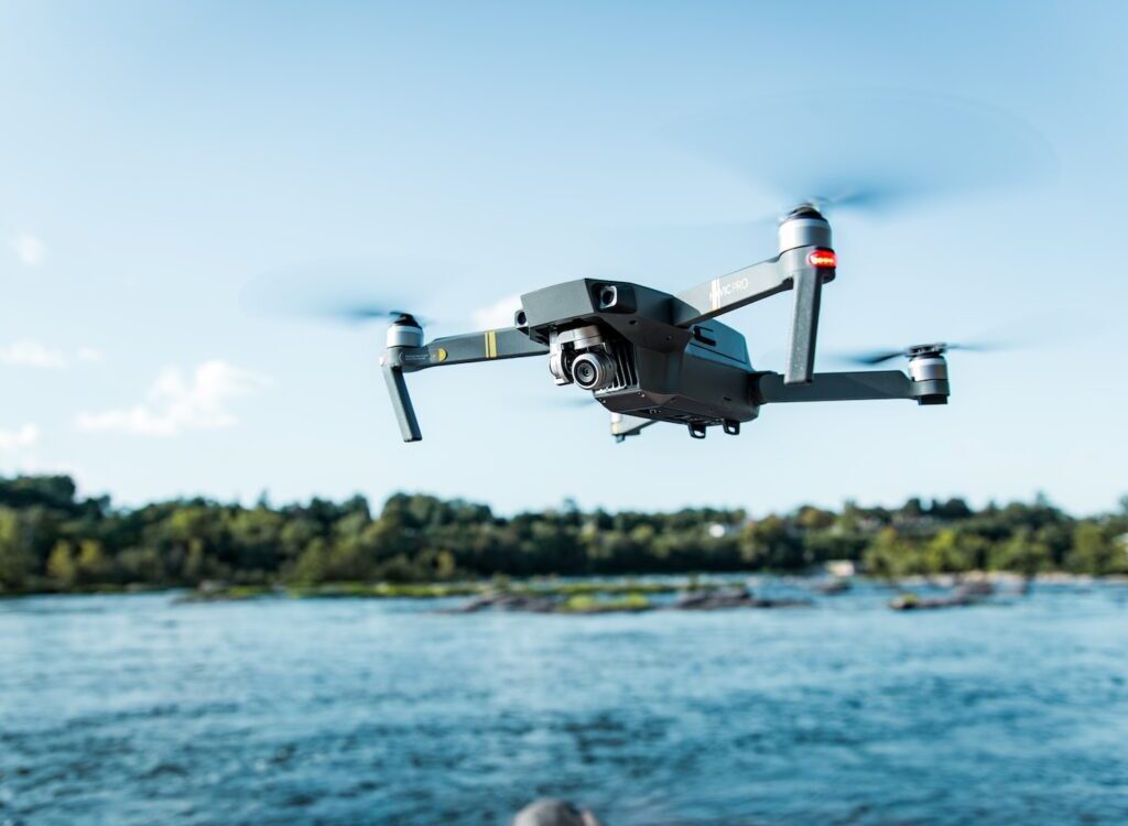 black DJI Mavi quadcopter near body of water