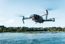 black DJI Mavi quadcopter near body of water