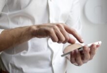 person holding white Android smartphone in white shirt