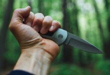 person holding gray and black knife