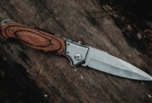 brown handle silver knife on brown wooden table