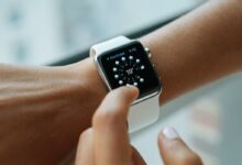 person wearing silver aluminium case Apple Watch with white Sports Band