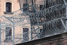 gray barbwire on fence near building during day