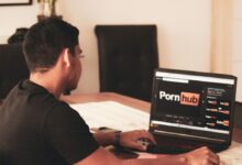 man in black t-shirt using black laptop computer