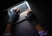 person in black long sleeve shirt using macbook pro