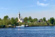 a body of water with a church in the background
