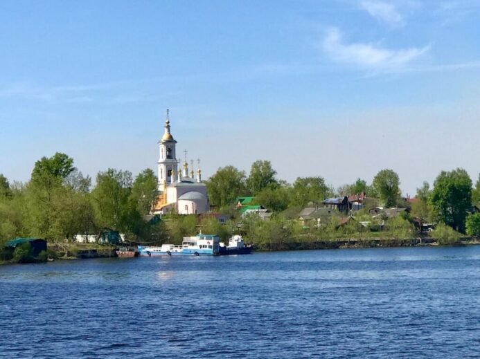 a body of water with a church in the background