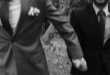 man in black suit jacket and woman in black and white floral long sleeve shirt